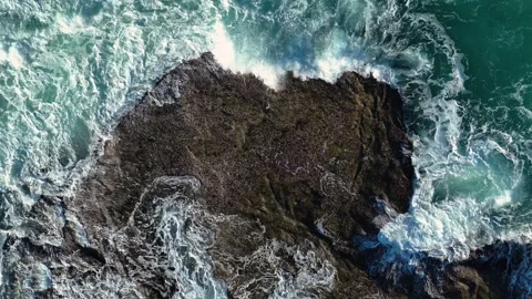 Overhead View Of Foaming Sea Waves Hitting Rocky Shore. Aerial Topdown Stock Footage 256773000
