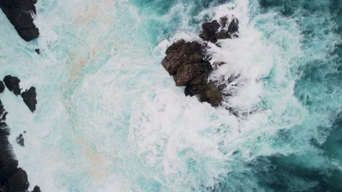 Overhead View Of Foamy Waves Breaking On Outcrops In Caion Beach Stock Footage 236643226