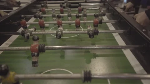 Overhead view of a foosball table with red and green player figures. Stock Footage 327624784