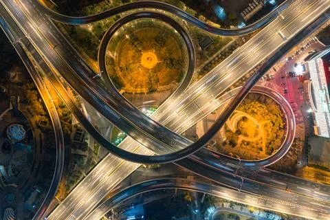 Overhead view of four intersecting traffic lines at night in town Photos