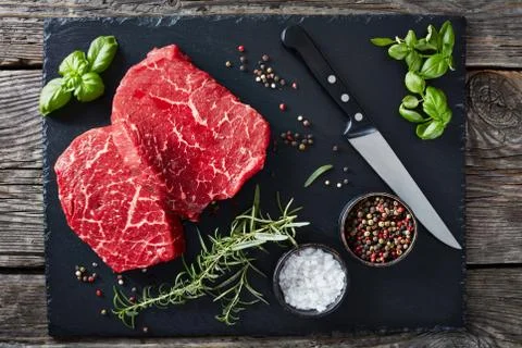 Overhead view of fresh raw beef steaks Stock Photos
