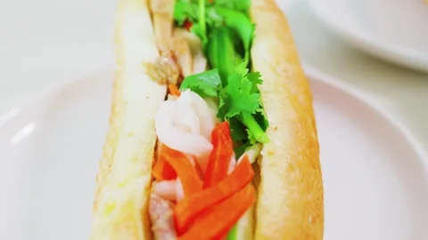 Overhead view of fresh Vietnamese banh mi sandwich with colorful vegetables Stock Footage 340184282