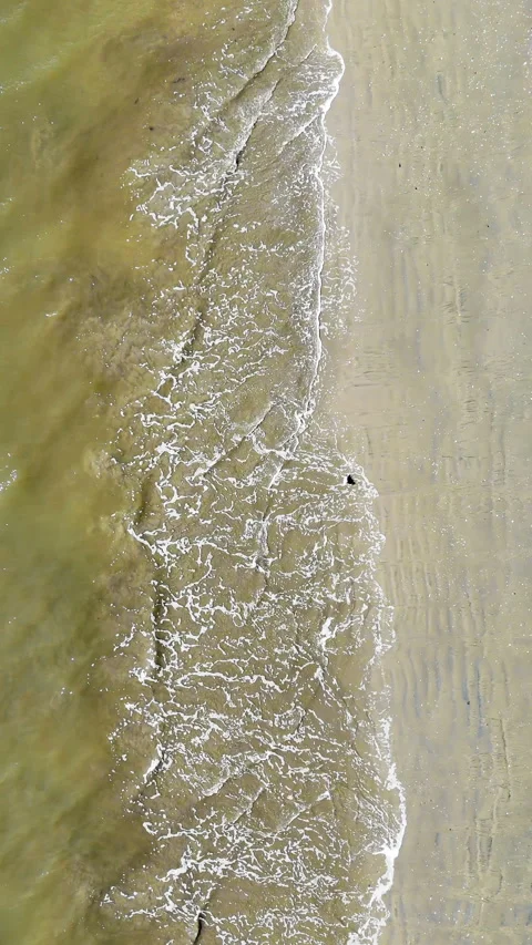 Overhead View of Gentle Waves on Sandy Beach. Aerial perspective of small waves Stock Footage 309409417