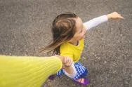 Overhead View Of A Girl Holding Her Mother's Hand Stock Photos
