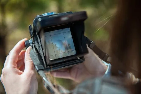 An overhead view of hands holding a medium format retro film camera. Close-up Stock Photos