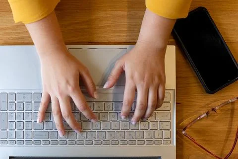 Overhead view of hands of plus size caucasian casual businesswoman using laptop Stock Photos