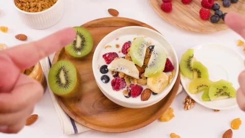 Overhead View of Hands Pointing at Healthy Yogurt Breakfast Bowl Stock Footage 337519465