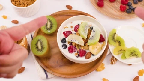 Overhead View of Hands Pointing at Healthy Yogurt Breakfast Bowl Stock Footage 337519927