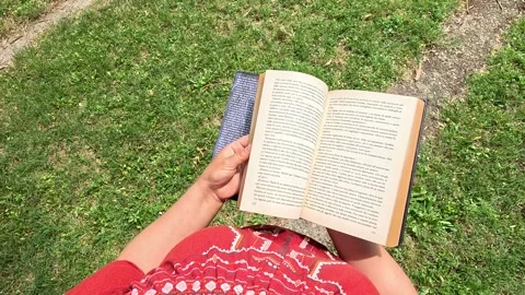 Overhead View of Hands Turning Pages of a Book Stock Footage 277494448