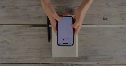 Overhead View Of Hands Using Smartphone For Calendar Planning... Stock Footage 332807916