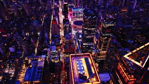 Overhead view of illuminated rooftop pool among skyscrapers Stockbeeldmateriaal 341031654