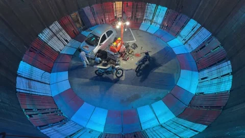 Overhead view inside a wall of death arena with a stunt rider climbing the 動画素材 347131071