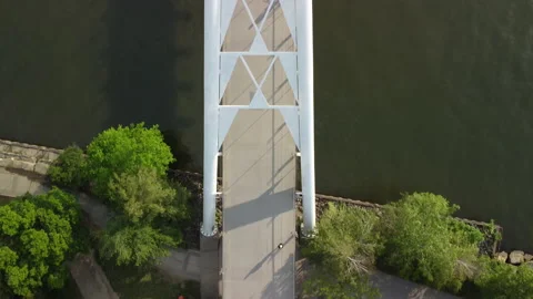 An overhead view of a kayaker passing under a pedestrian bridge Stock Footage 163136949