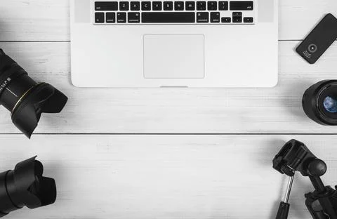 Overhead view laptop with camera accessories white desk . High quality and Stock Photos