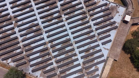 Overhead view of large solar panel array installed on flat rooftop, rows of Video stock 342752765