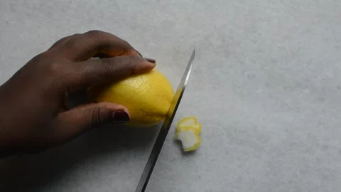 Overhead view of lemon being cut into slices Stock Footage 279153896