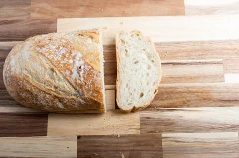 Overhead view of loaf of bread on cutting board  rustic food scene Stock Photos