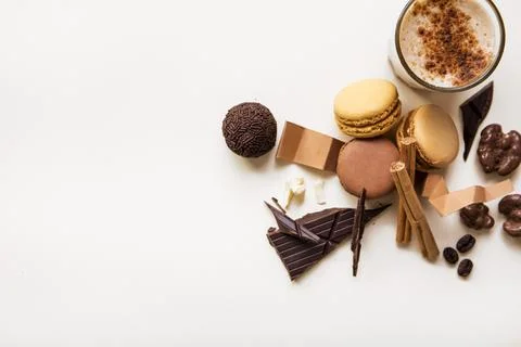 Overhead view macaroons chocolate ball coffee glass white background . High Stock Photos