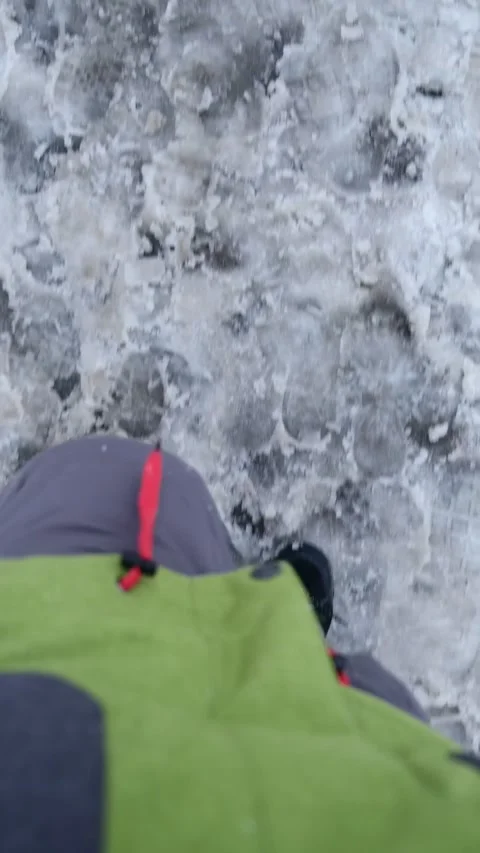 Overhead view of males legs walking by wet snow Stock Footage 220682429