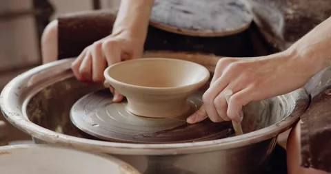 Overhead view of man making plate on pottery wheel. Potter shapes the clay Stock Footage 207069426