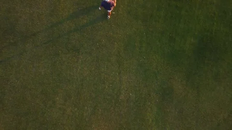 Overhead view of a man swinging on a golf club course at sunset. Copy space.. Stock Footage 252603865