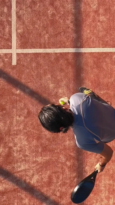Overhead view of a man who is kicking the ball to play paddle tennis. Stock Footage 310104259