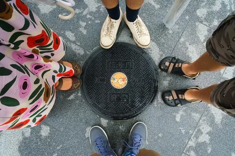An overhead view of a manhole  with a geometric pattern and small painting Stock Photos