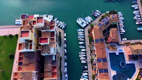 Overhead view of marina canal flanked by terracotta rooftops and moored boats, Stock Footage 337465067