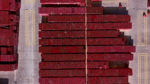 Overhead view of massive red beverage crate stacks arranged in rows on a marked Stock Footage 342478571