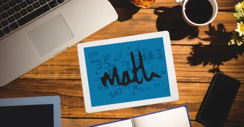 Overhead view of math text in digital tablet by office supplies on table Stock Photos