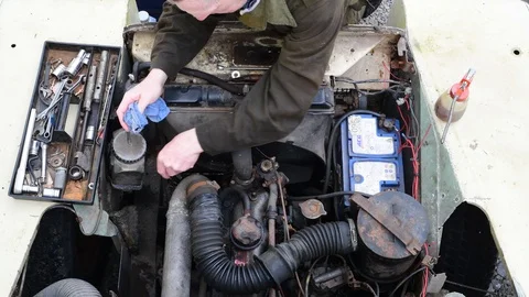 Overhead view of mechanic checking oil level on engine Stock Footage 127637841
