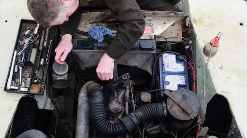 Overhead view of mechanic working on vehicle engine Stock Footage 127638464