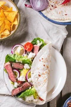 Overhead view on mexican style dinner with tacos, vegetables, nachos chips .. Stock Photos