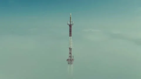An overhead view of a microwave relay or radio tower and a cell tower against a Stock Footage 144246857