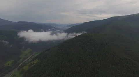 Overhead view of the mountains and forests in the fog Stock Footage 67109613