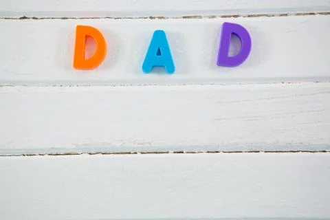 Overhead view of multi colored dad text on white table 스톡 사진