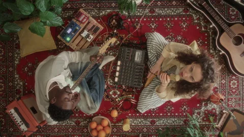Overhead View of Music Duo Playing Guitar and Singing on Retro Rug Stock Footage 339850282