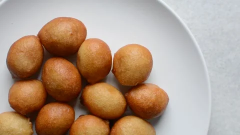 Overhead view of nigerian puff-puff on a white plate Stock Footage 279157676