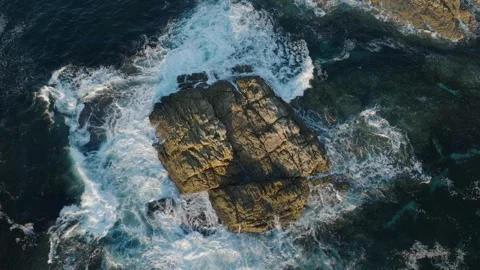 Overhead View Of Ocean Waves Crashing On The Rocky Outcrop. - aerial Stock Footage 253489014