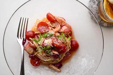 Overhead View of Octopus Spaghetti Pasta with Cherry Tomatoes in Glass Dish Stock Photos