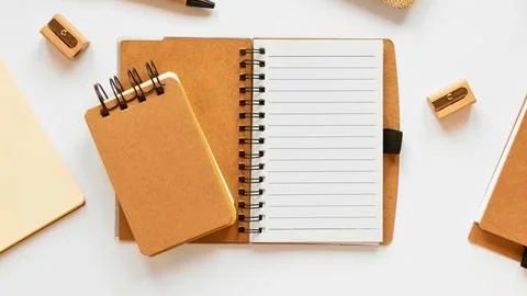 Overhead view of open notebooks and stationery supplies Stock Photos