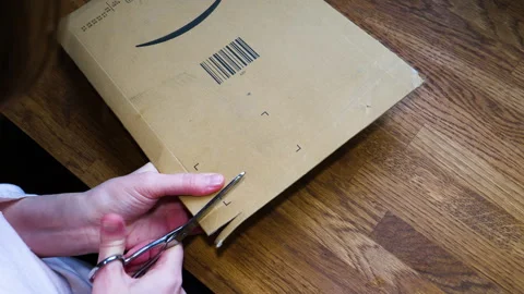 Overhead View of Opening Amazon Prime Parcel with Scissors Stock Footage 303868114