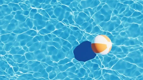 Overhead view of orange and white beach ball floating on rippling blue swim.. Stock Footage 332152010