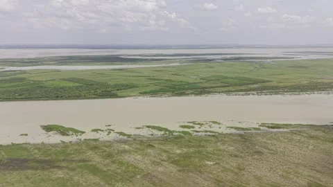 Overhead view of Padma River surrounded by green fields and rural villages Stock Footage 344514291