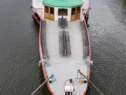 Overhead view of passenger boat deck showing wooden benches, cabin with gre.. Photos
