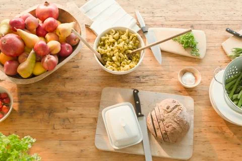 Overhead view pasta, fruit and bread on dining table Stock Photos