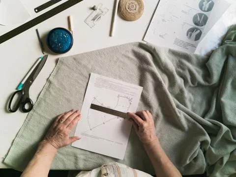 An overhead view of a pattern held by an elderly woman Foto stock