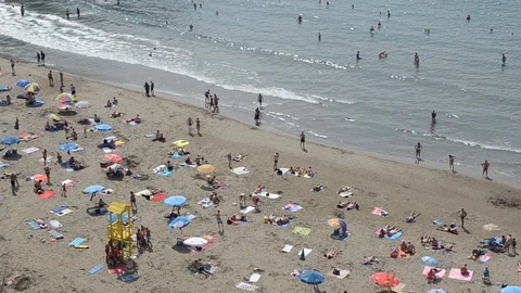 Overhead view of people on crowded beach. Tourists enjoy on sandy beach Stock Footage 116657371