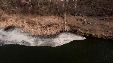 Overhead view of people resting at the beach of early spring lake Stock Footage 151640927