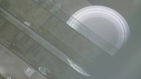 Overhead View of People Walking on Modern Indoor Balcony with Glass Railings Stock Footage 334052774